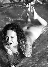 Nikki strips off naked in a spanish beach exposing her nice tits and give her dick a splash